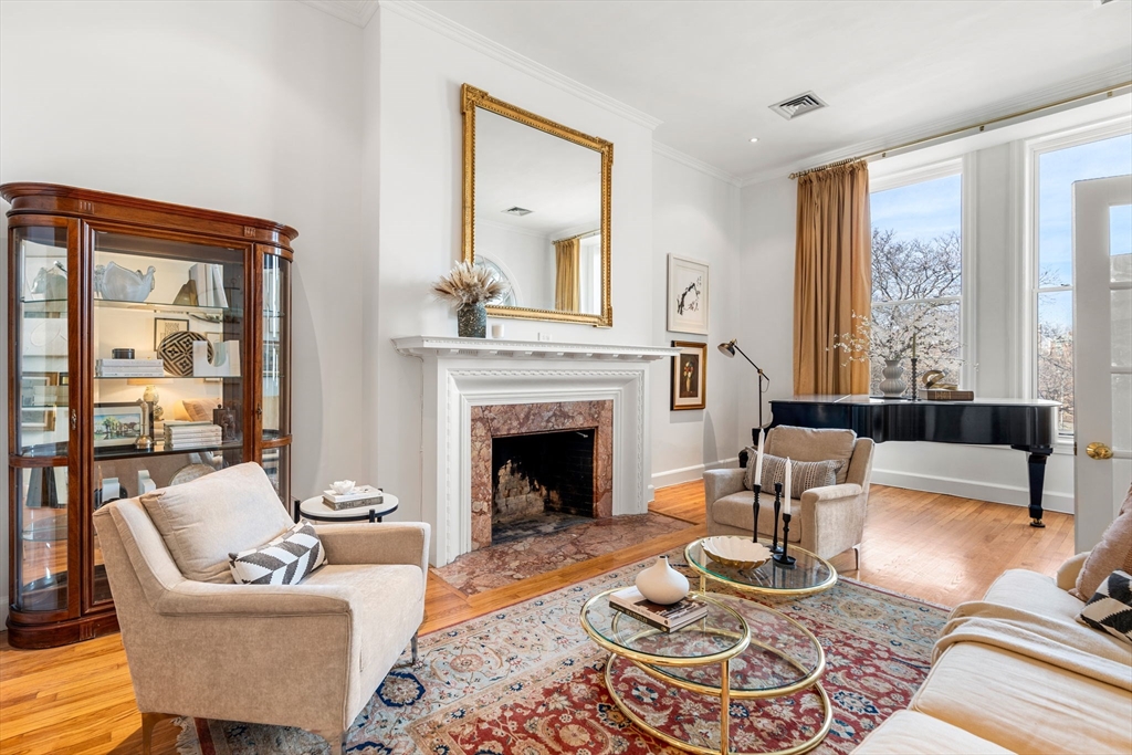 120 Beacon Street, Unit 3 Boston, MA 02116 - Photo 3 of 19 a living room with furniture fireplace and a large window