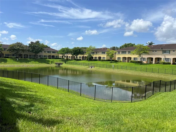 a view of a lake with a house in the background