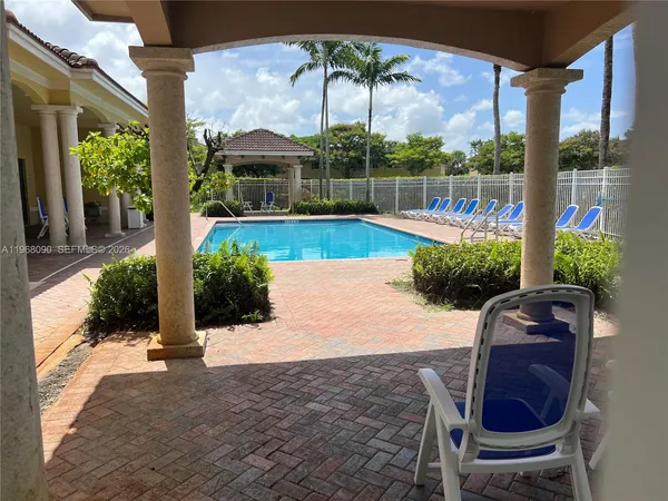 a view of a chairs and table in the patio