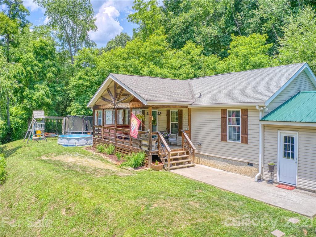 485 Loop Road Clyde, NC 28721 - Photo 1 of 33 a view of house with outdoor seating and covered with trees
