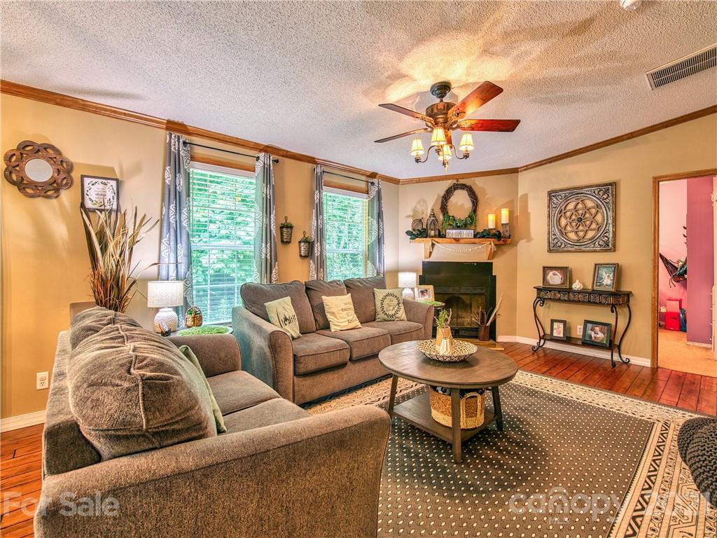 485 Loop Road Clyde, NC 28721 - Photo 7 of 33 a living room with fireplace furniture and a large window