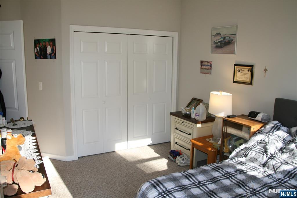 485 Saddle River Road, Unit 13 Saddle Brook, NJ 07663 - Photo 2 of 10 a bedroom with a bed and a window