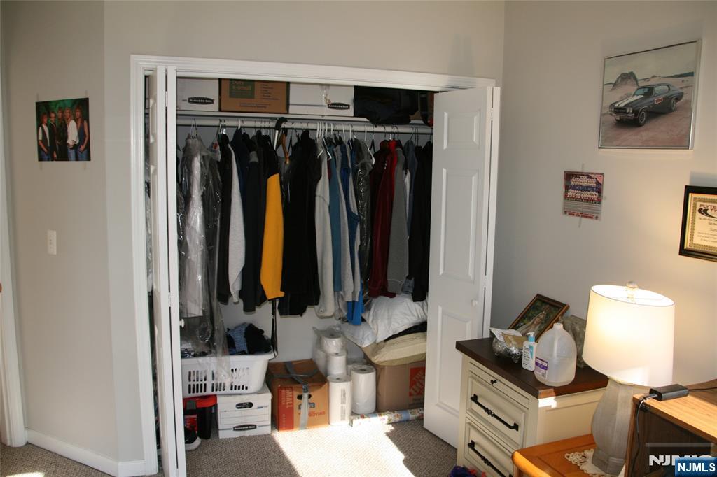 485 Saddle River Road, Unit 13 Saddle Brook, NJ 07663 - Photo 3 of 10 a view of walk in closet with clothes and shoes