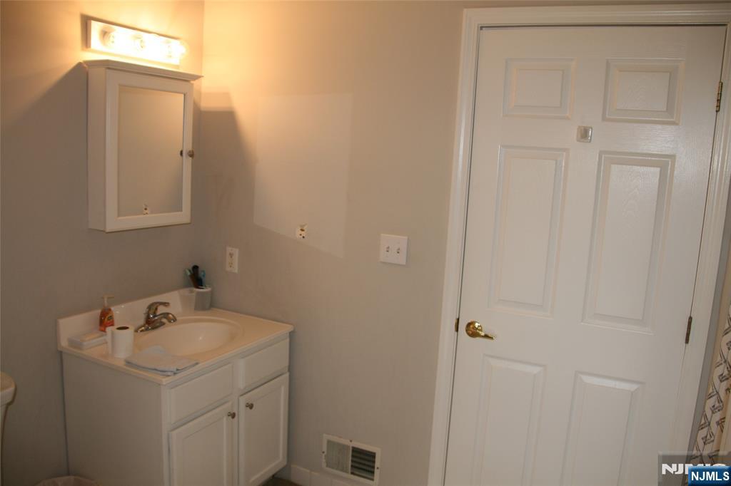 485 Saddle River Road, Unit 13 Saddle Brook, NJ 07663 - Photo 7 of 10 a bathroom with a sink and a mirror