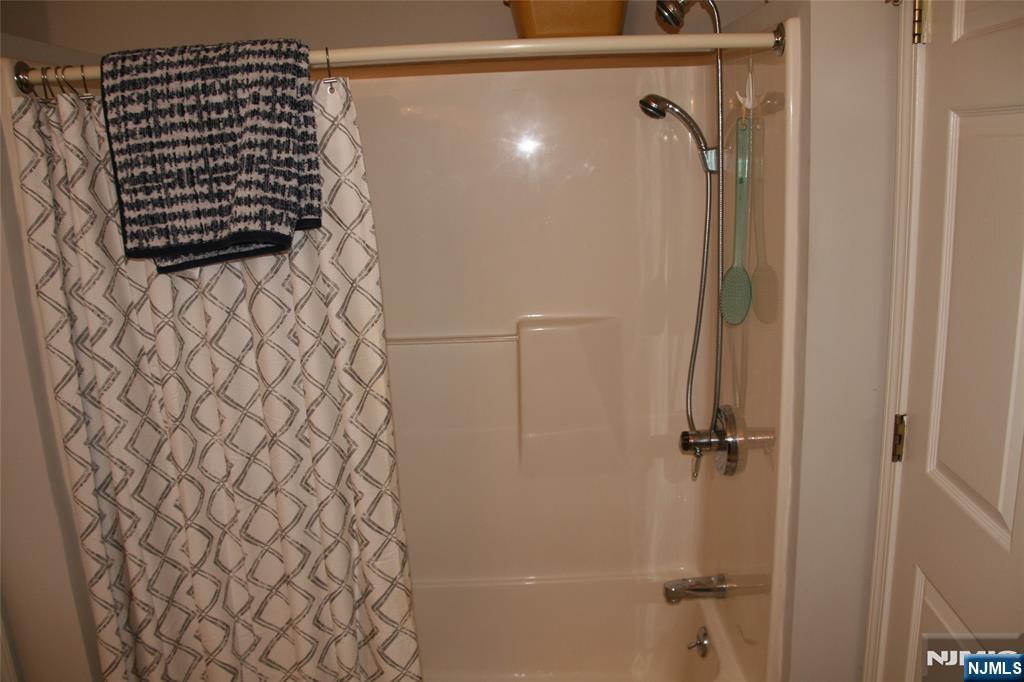 485 Saddle River Road, Unit 13 Saddle Brook, NJ 07663 - Photo 8 of 10 a bathroom with a shower and a shower curtain