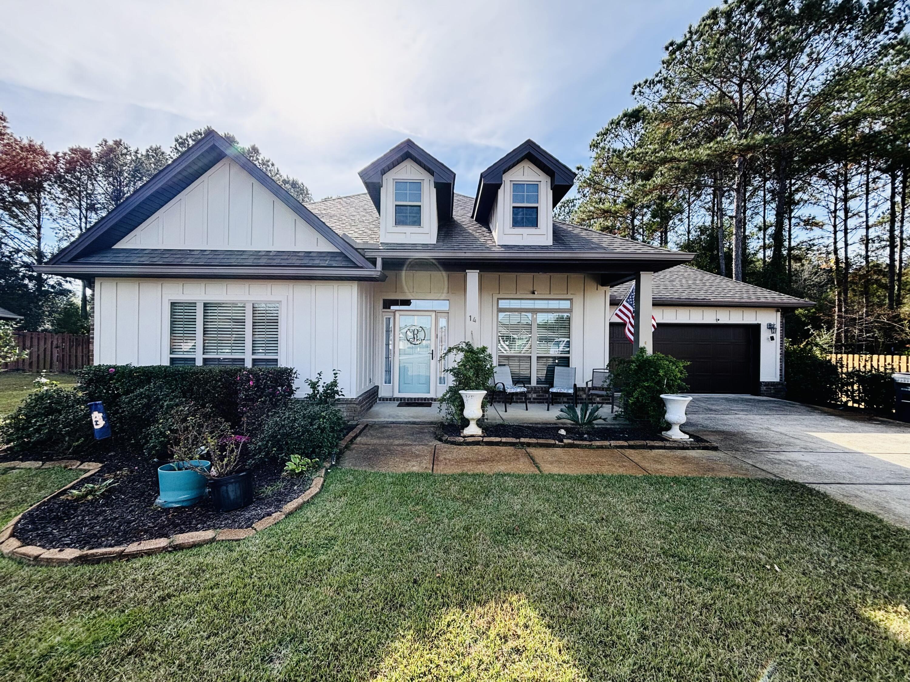 14 Lullaby Lane Freeport, FL 32439 - Photo 1 of 1 a front view of a house with sitting area and garden