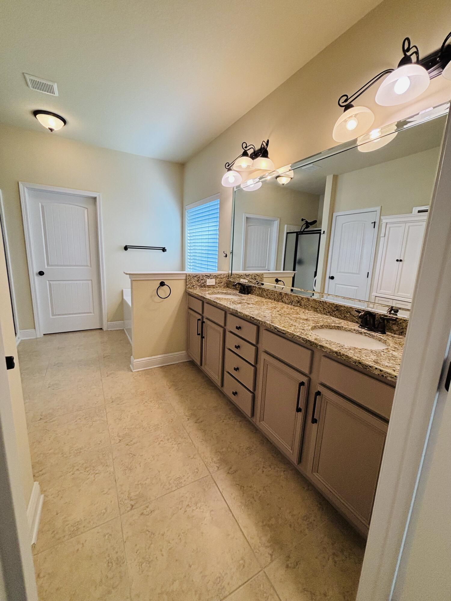 14 Lullaby Lane Freeport, FL 32439 - Photo 11 of 15 a large kitchen with a lot of counter space and wooden floor