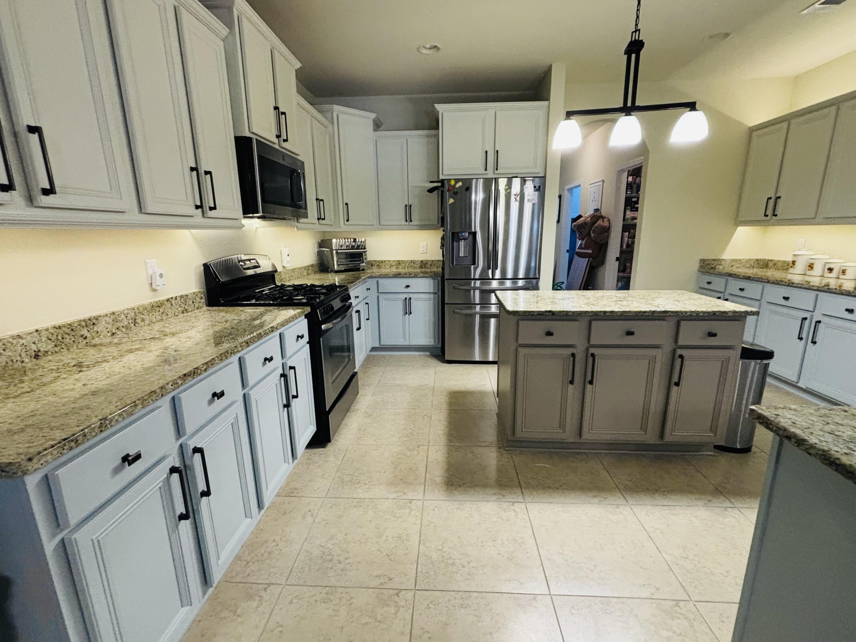 14 Lullaby Lane Freeport, FL 32439 - Photo 2 of 15 a kitchen with stainless steel appliances a stove refrigerator sink and cabinets