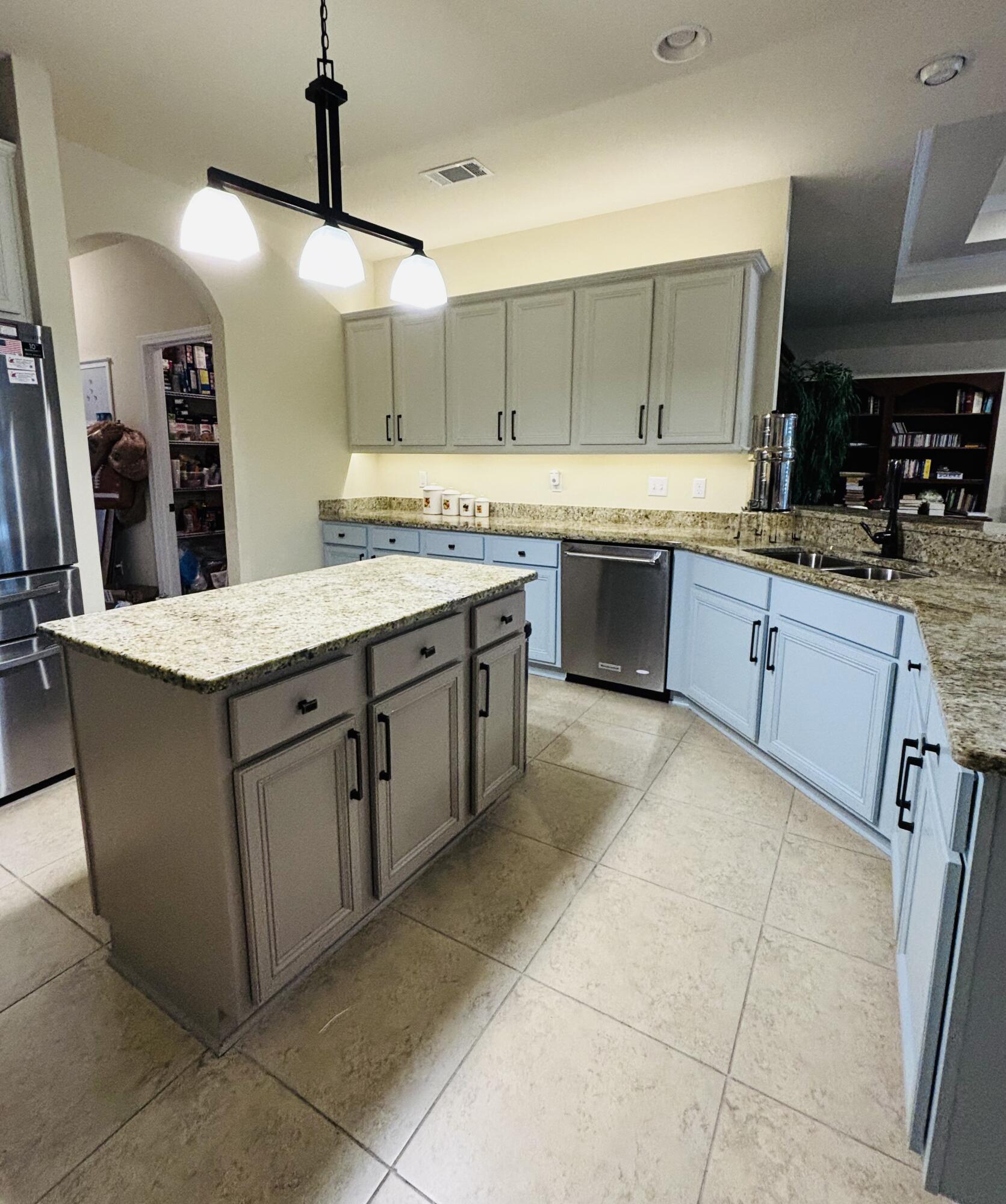 14 Lullaby Lane Freeport, FL 32439 - Photo 3 of 15 a large kitchen with a stove a sink a counter space and cabinets