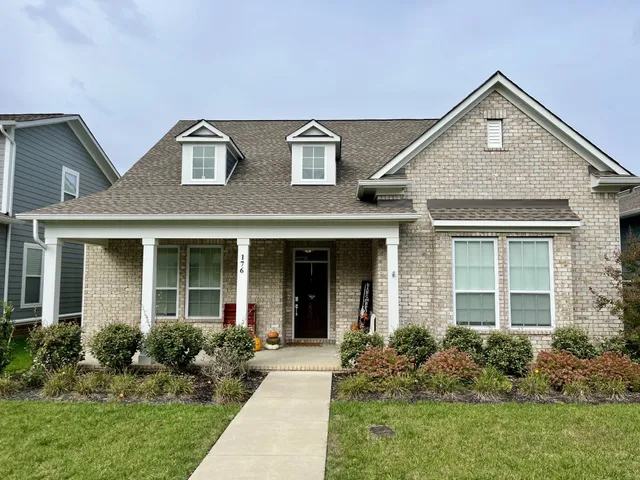 a front view of a house with garden