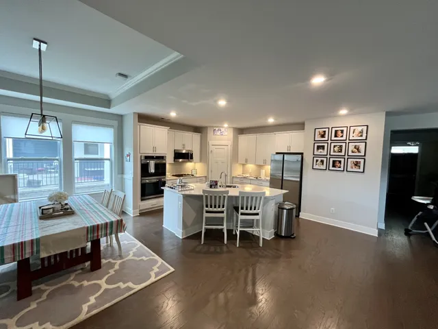 a kitchen with stainless steel appliances granite countertop a stove refrigerator and cabinets