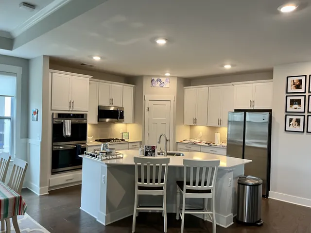 a kitchen with stainless steel appliances granite countertop a stove and a microwave