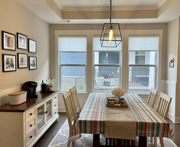 a kitchen with kitchen island granite countertop a stove a sink a refrigerator and white cabinets