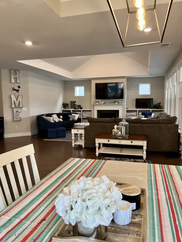 a view of a dining room kitchen with furniture a flat screen tv and kitchen view