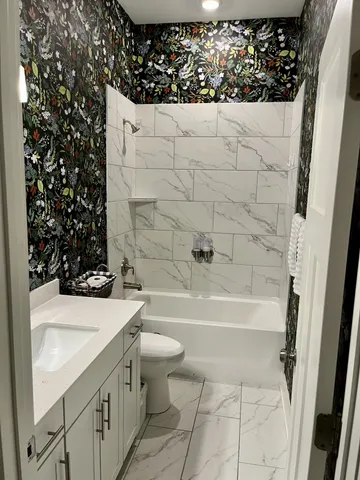 a spacious bathroom with a double vanity sink mirror and shower