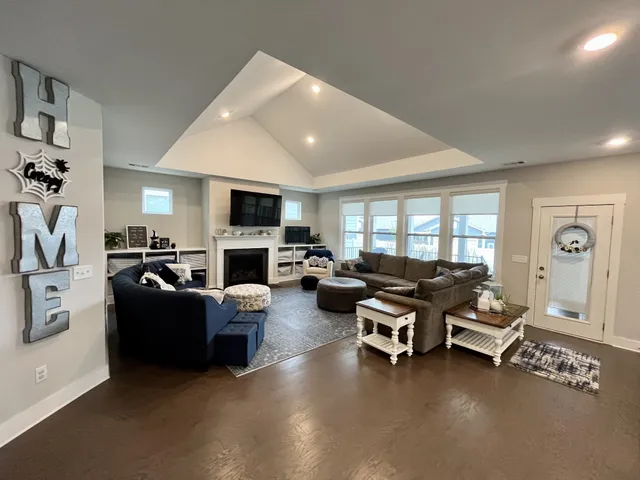 a living room with furniture flat screen tv and a fireplace