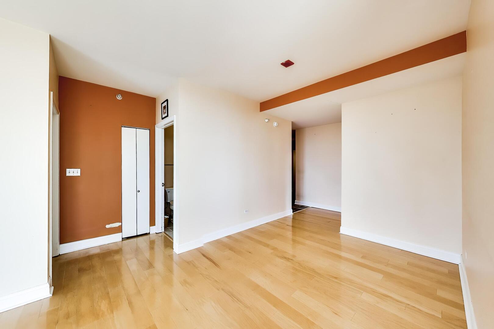 1101 South State Street, Unit 1307 Chicago, IL 60605 - Photo 13 of 31 a view of an empty room with wooden floor