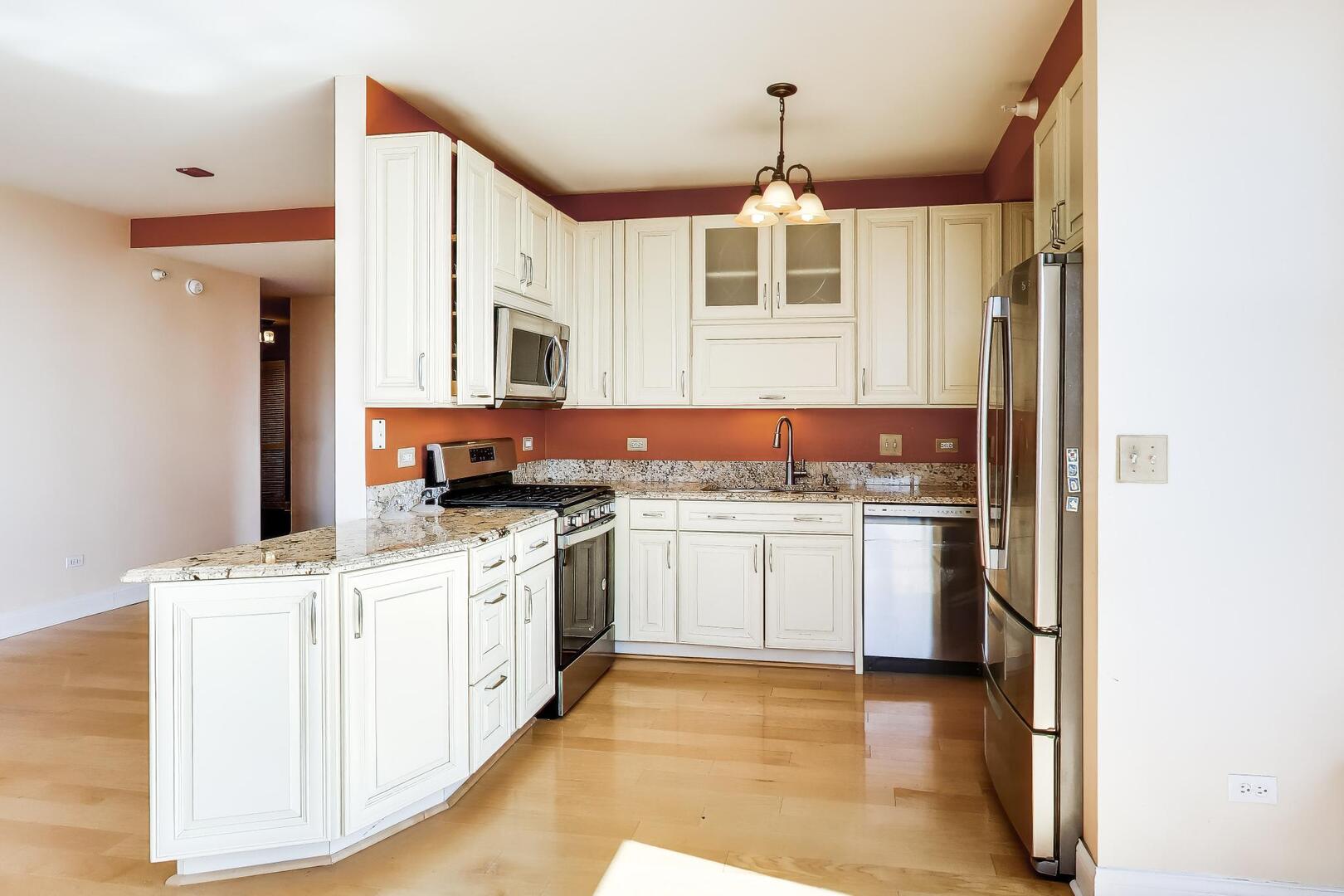 1101 South State Street, Unit 1307 Chicago, IL 60605 - Photo 15 of 31 a kitchen with stainless steel appliances granite countertop a stove and a sink
