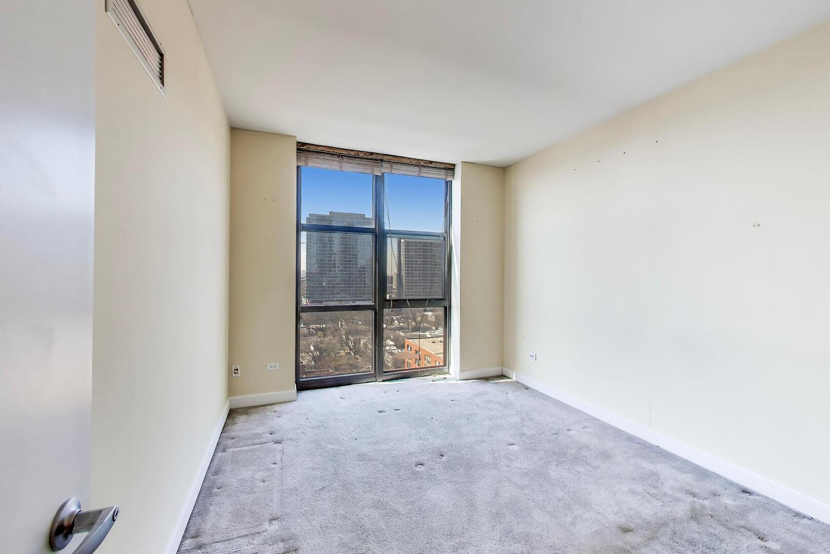 1101 South State Street, Unit 1307 Chicago, IL 60605 - Photo 19 of 31 a view of an empty room with a cabinet