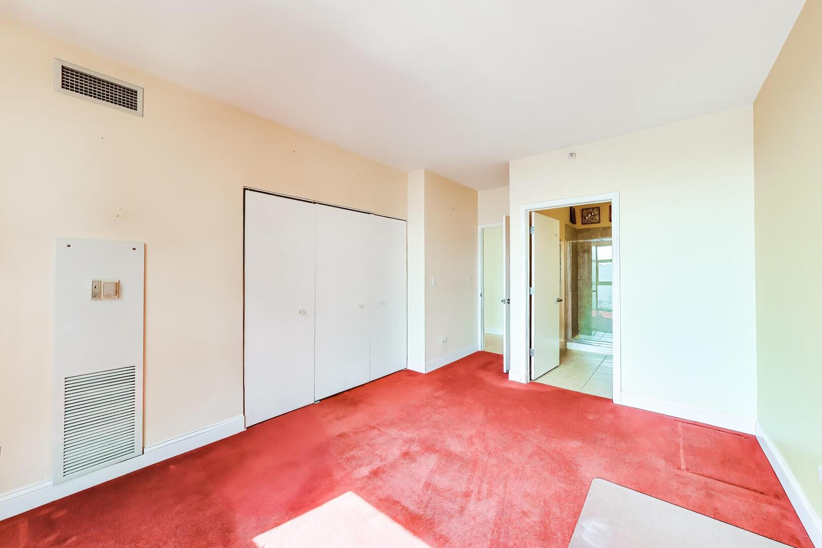 1101 South State Street, Unit 1307 Chicago, IL 60605 - Photo 21 of 31 a bed room with a bed and a large mirror