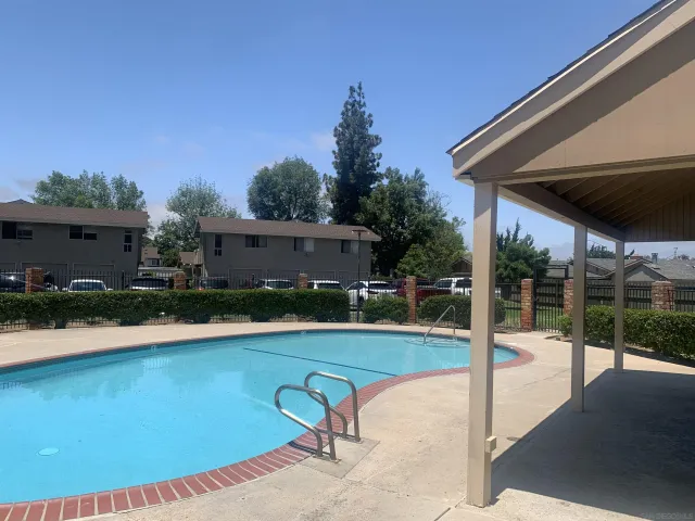 a swimming pool with outdoor seating and yard