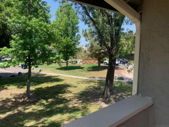 a balcony with furniture and potted plants