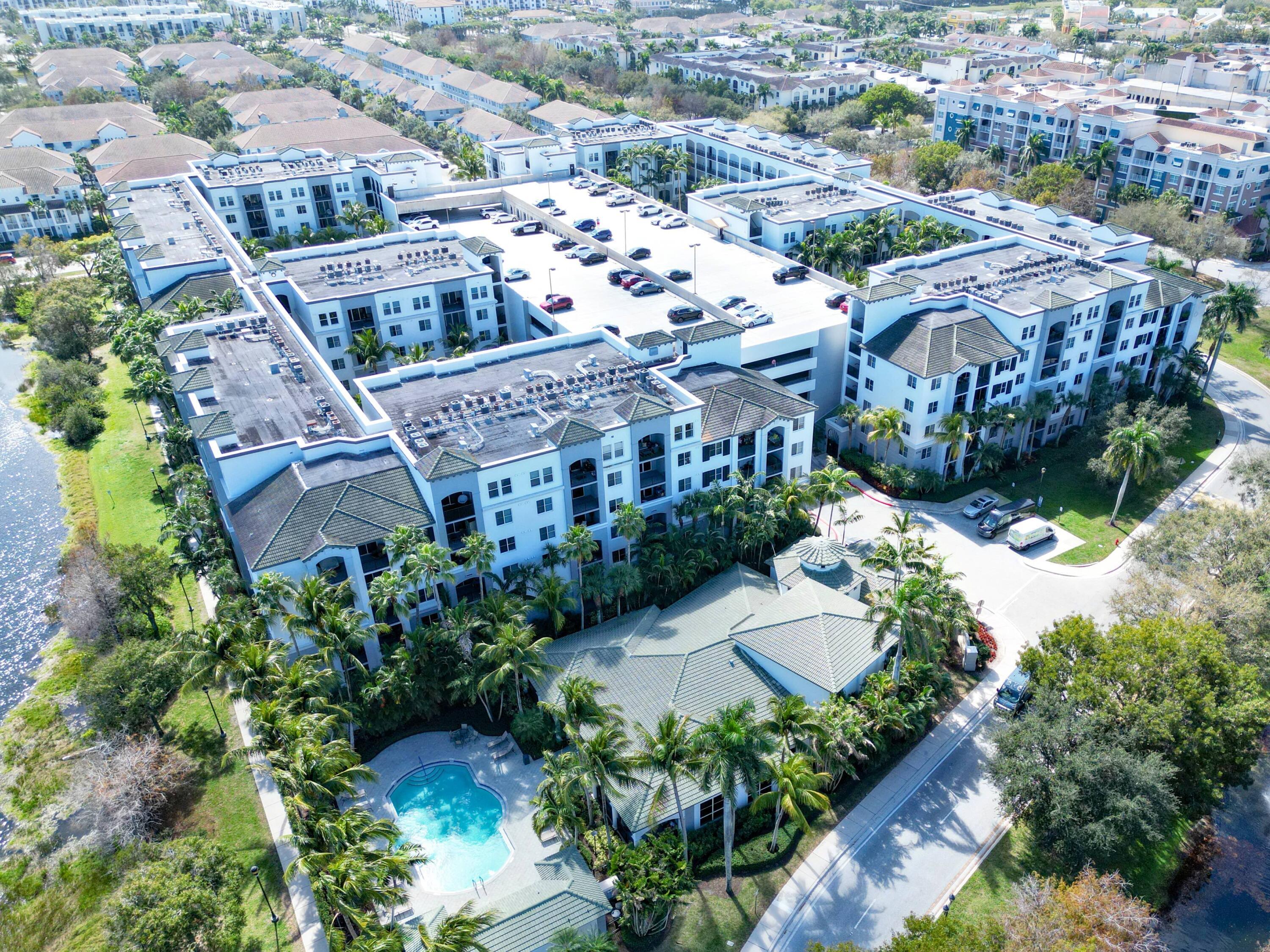 1690 Renaissance Commons Boulevard, Unit 1412 Boynton Beach, FL 33426 - Photo 45 of 49 an aerial view of multiple houses with yard