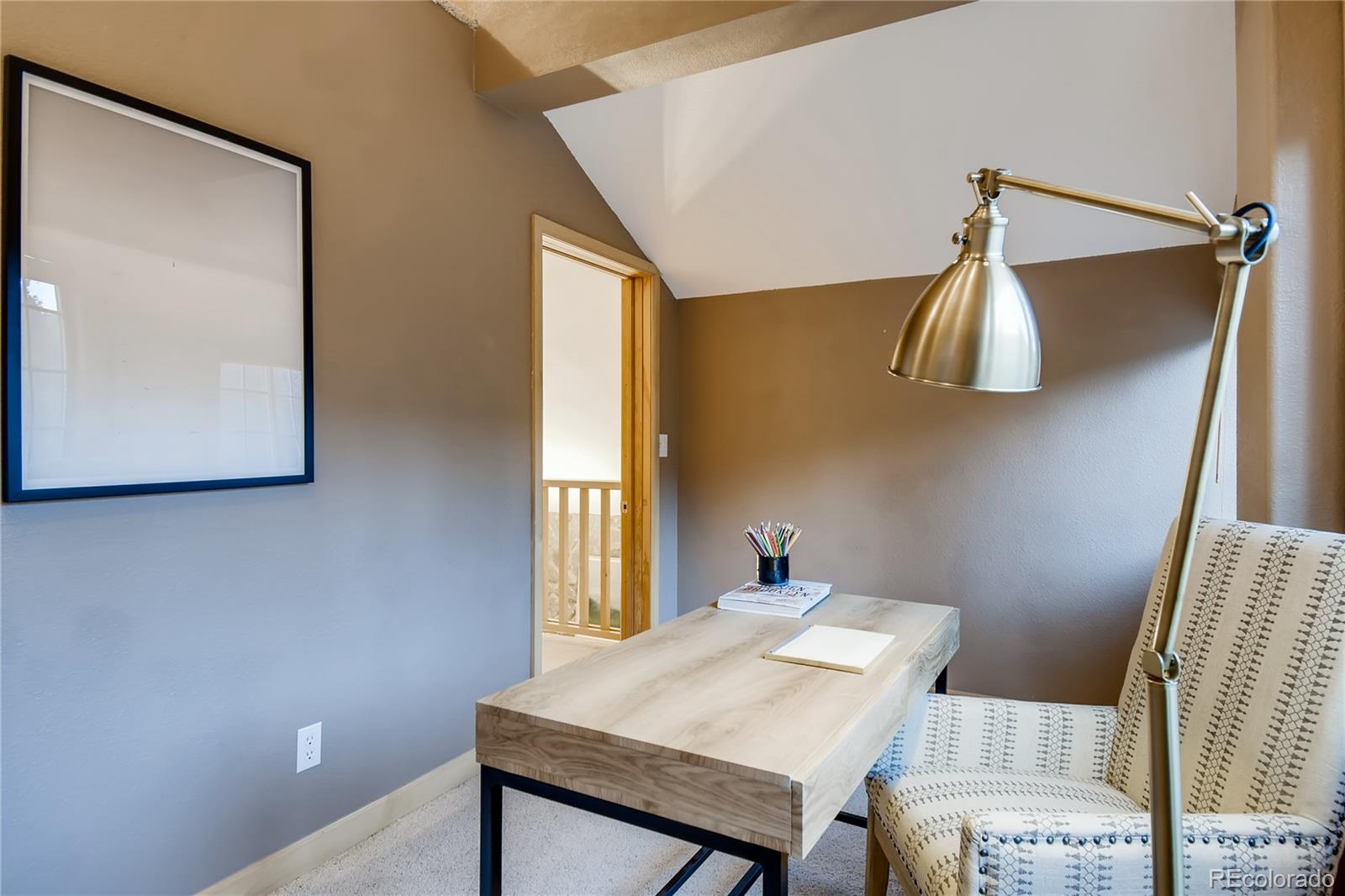 32104 Snowshoe Road Evergreen, CO 80439 - Photo 19 of 36 a view of a room that has a table and chairs in it