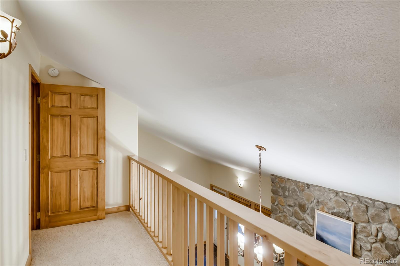 32104 Snowshoe Road Evergreen, CO 80439 - Photo 20 of 36 a view of a hallway with staircase