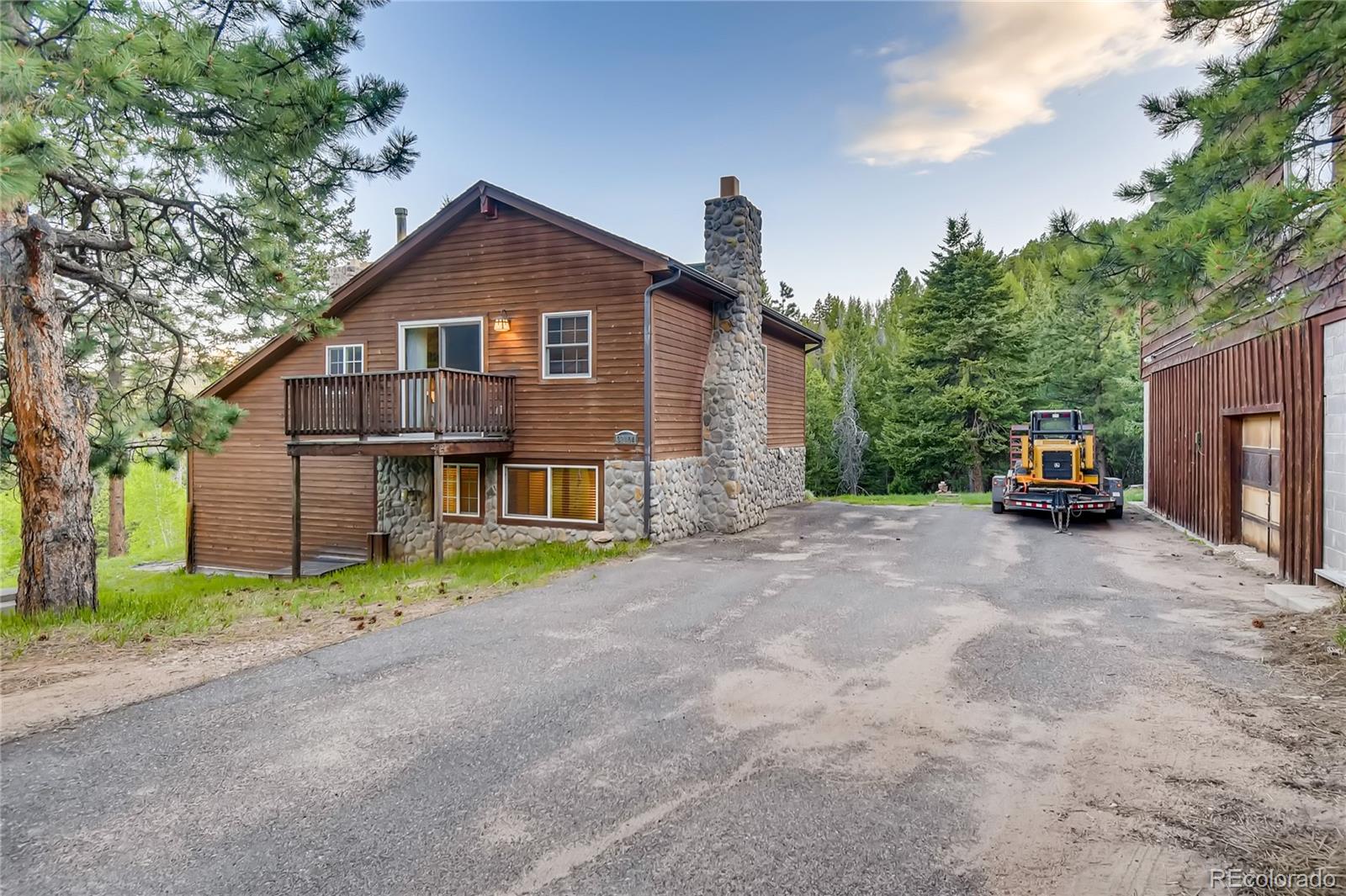 32104 Snowshoe Road Evergreen, CO 80439 - Photo 26 of 36 a view of house with outdoor space and street view