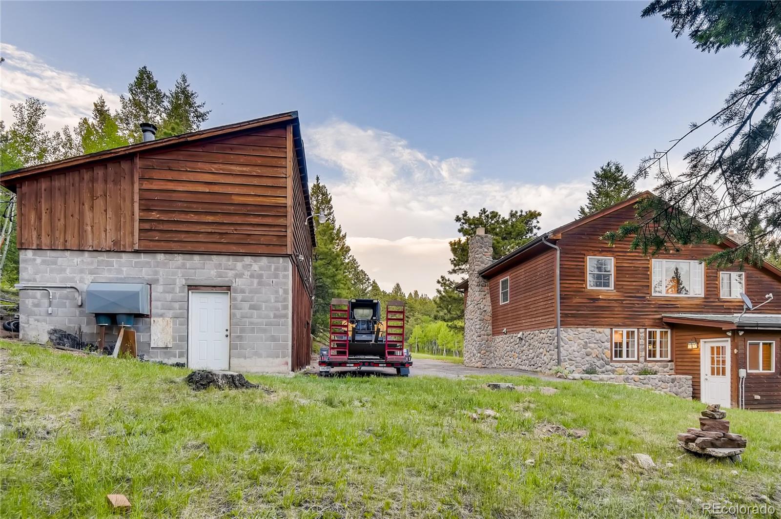 32104 Snowshoe Road Evergreen, CO 80439 - Photo 27 of 36 a view of a house with a yard