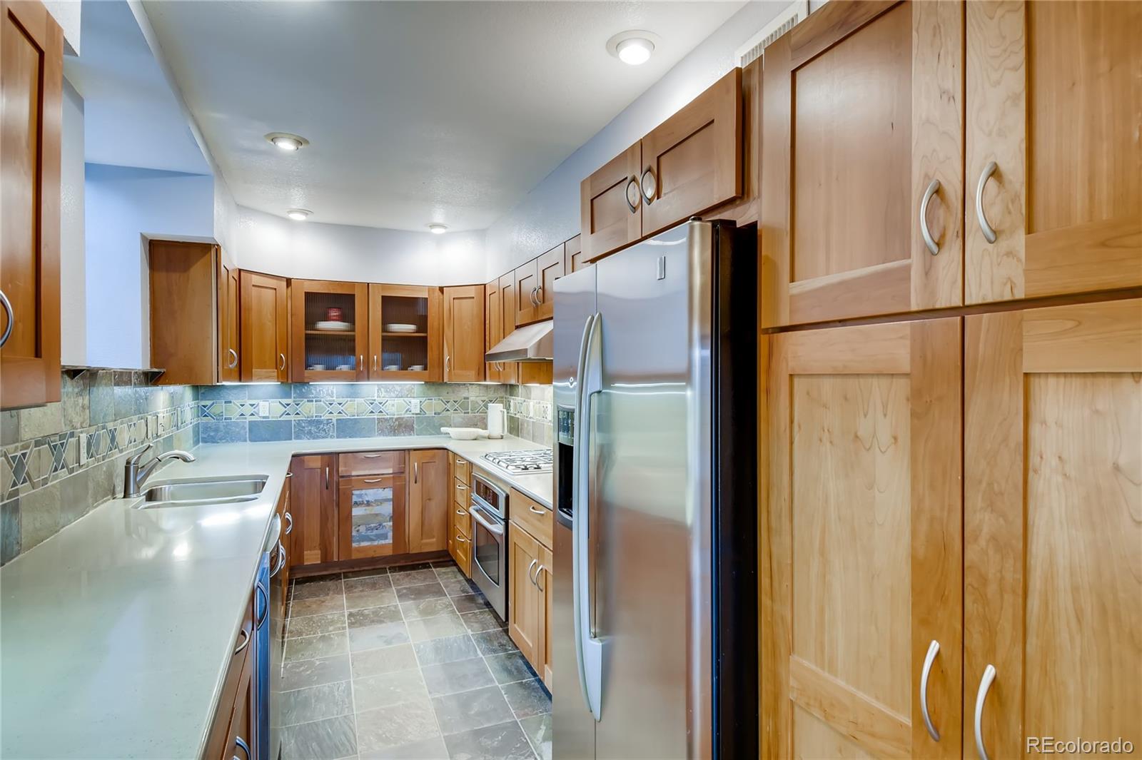 32104 Snowshoe Road Evergreen, CO 80439 - Photo 8 of 36 a kitchen with stainless steel appliances granite countertop a refrigerator and a sink