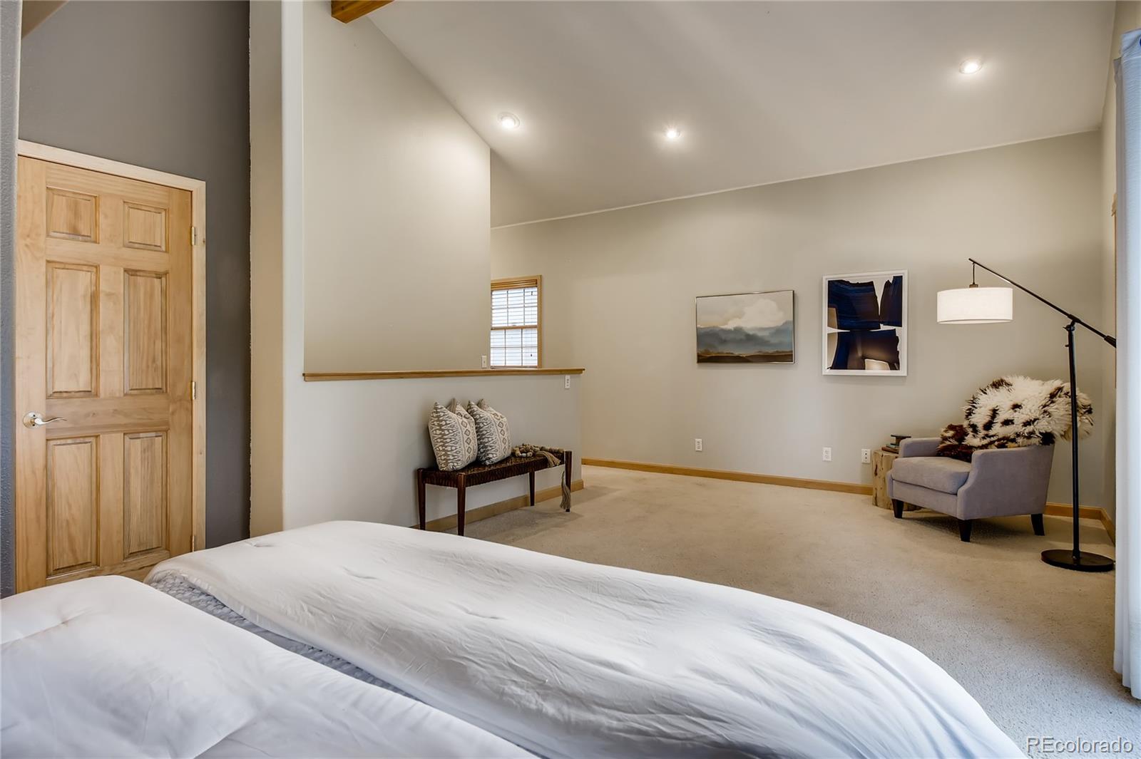 32104 Snowshoe Road Evergreen, CO 80439 - Photo 10 of 36 a bedroom with a bed and a chair