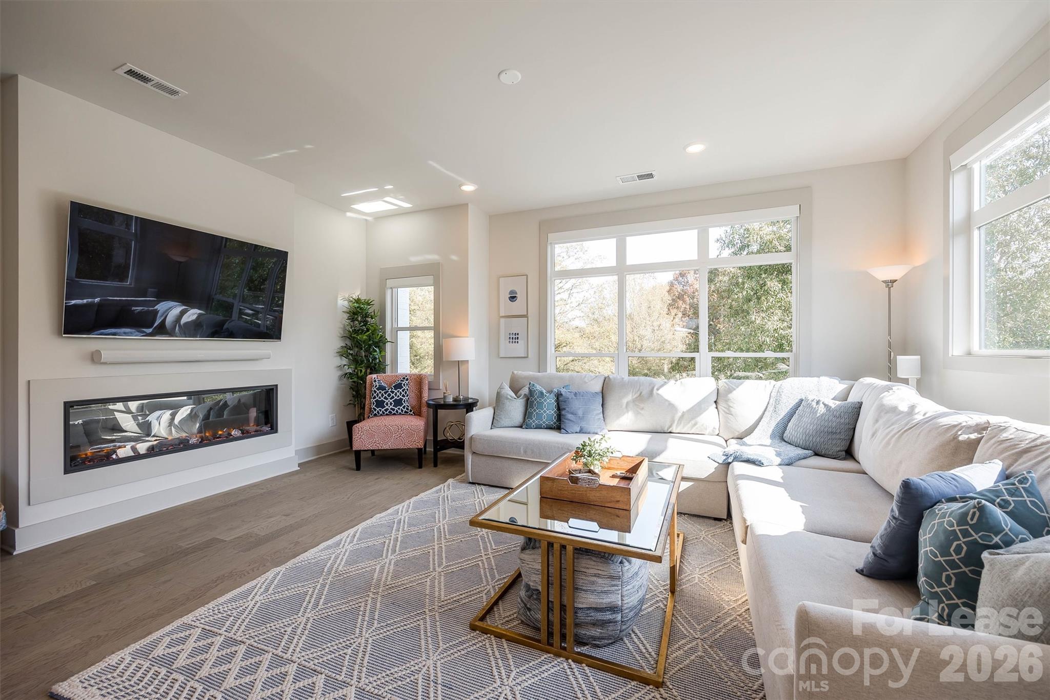 2319 Wesley Village Road Charlotte, NC 28208 - Photo 20 of 44 a living room with furniture a flat screen tv and a fireplace