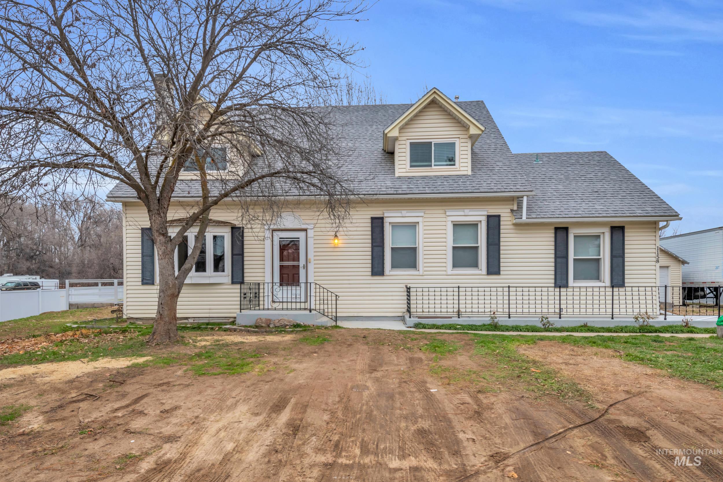 1158 South Powerline Road Nampa, ID 83686 - Photo 11 of 50 New england style home with a shingled roof