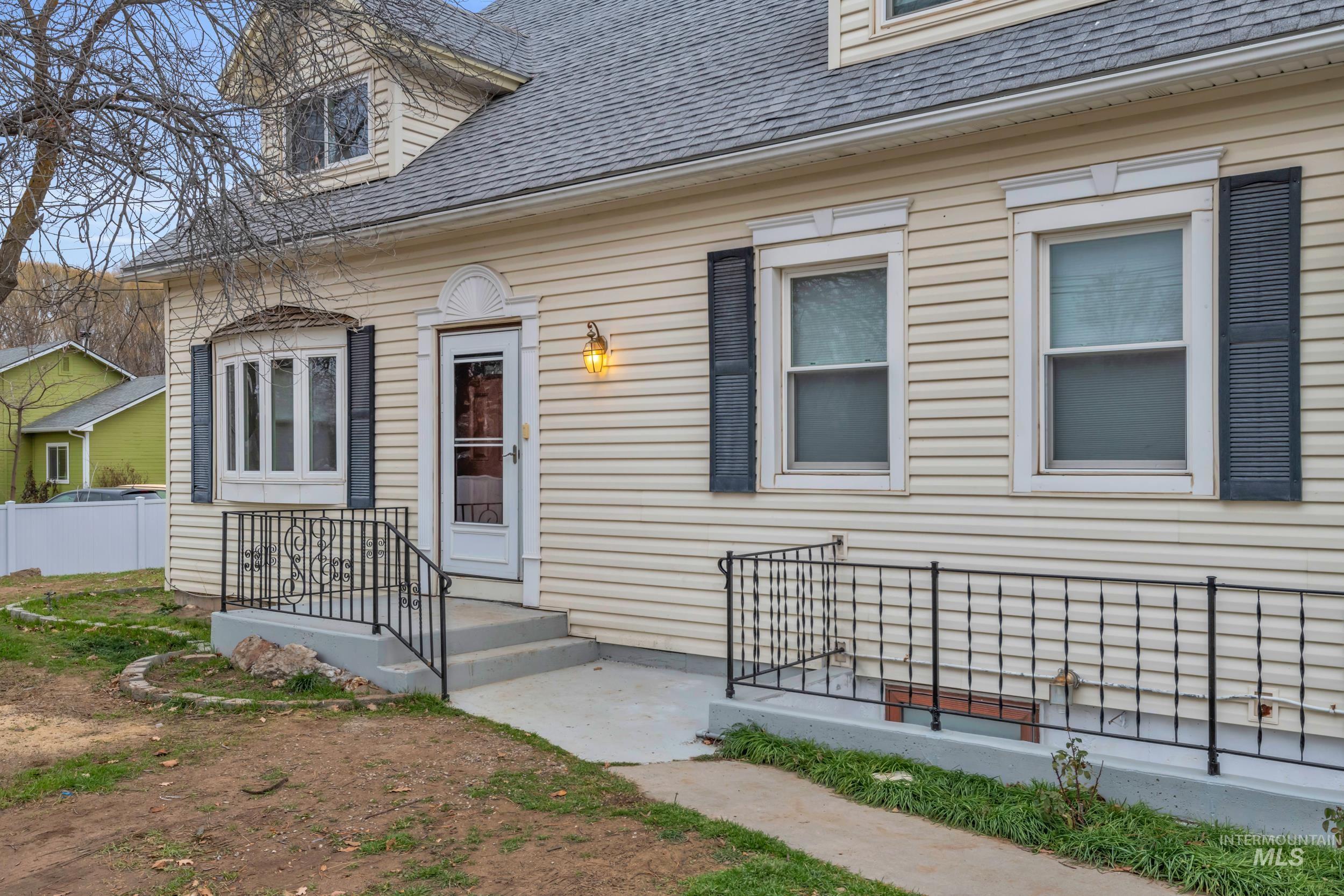 1158 South Powerline Road Nampa, ID 83686 - Photo 12 of 50 View of exterior entry with a shingled roof