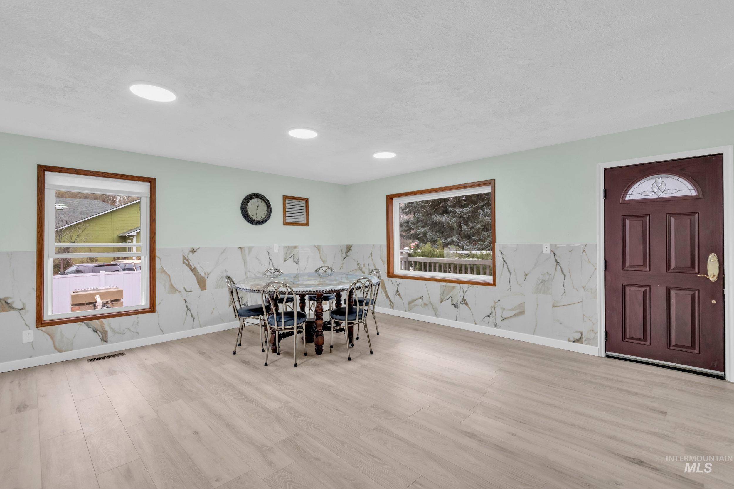 1158 South Powerline Road Nampa, ID 83686 - Photo 18 of 50 Dining area featuring wood finished floors and wainscoting