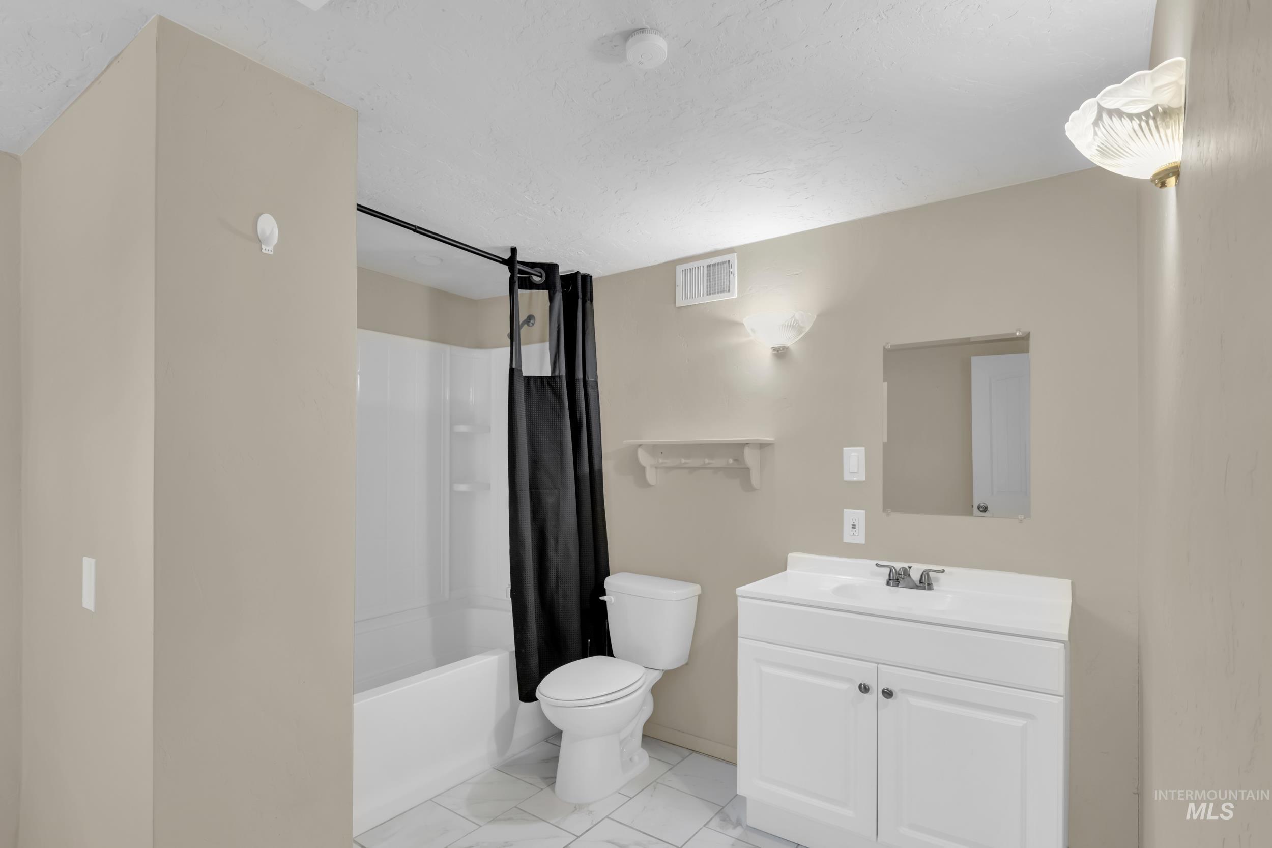 1158 South Powerline Road Nampa, ID 83686 - Photo 21 of 50 Full bathroom featuring shower / tub combo, vanity, and light marble finish flooring