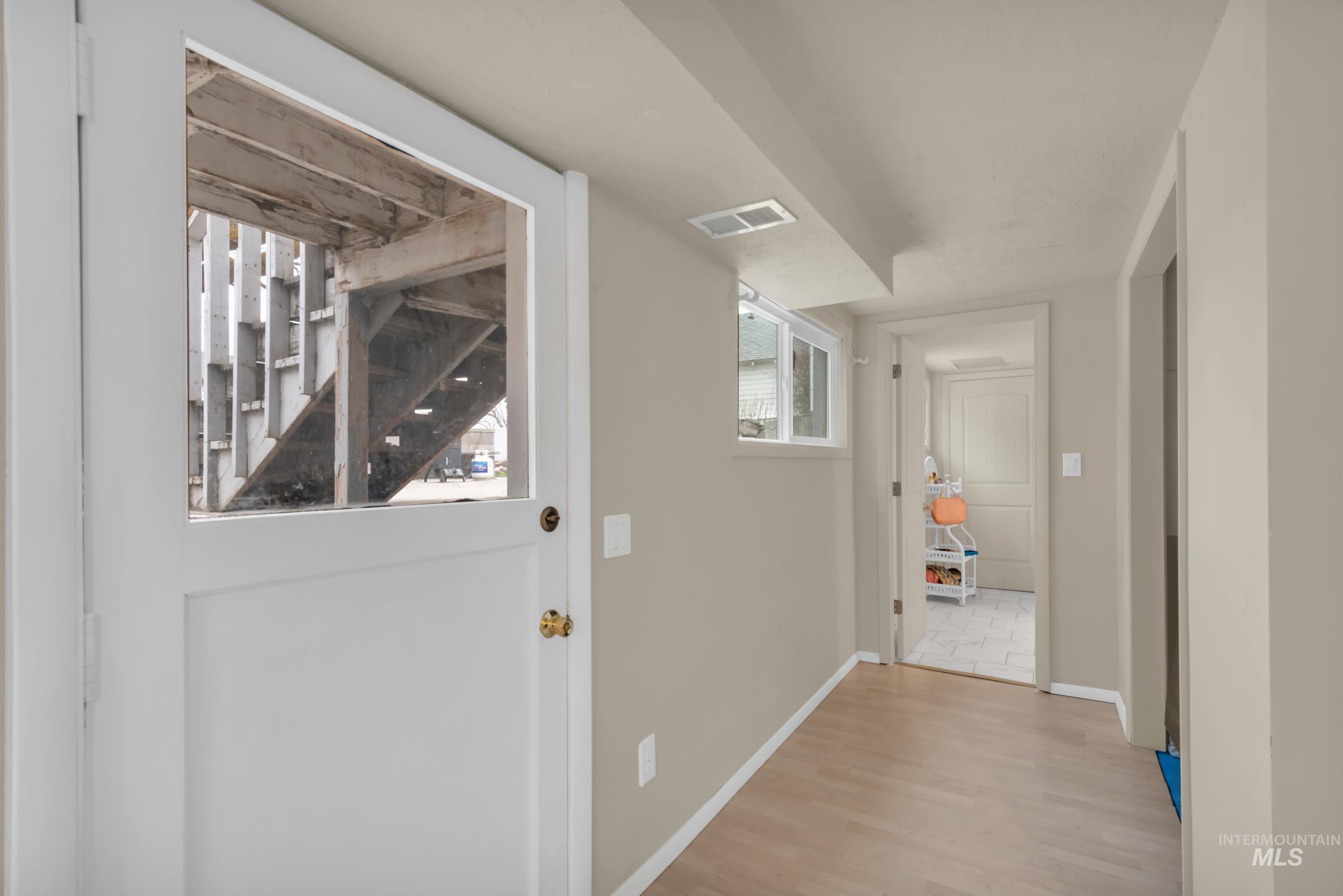 1158 South Powerline Road Nampa, ID 83686 - Photo 22 of 50 Hall featuring light wood-style flooring and baseboards