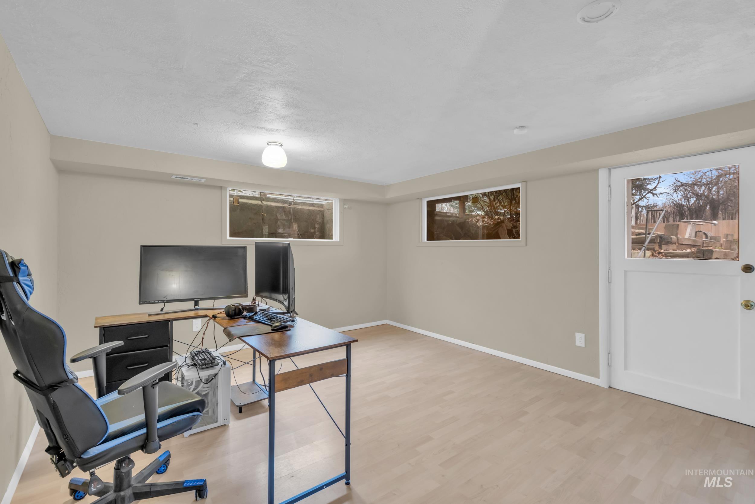 1158 South Powerline Road Nampa, ID 83686 - Photo 23 of 50 Home office featuring light wood-style floors and baseboards