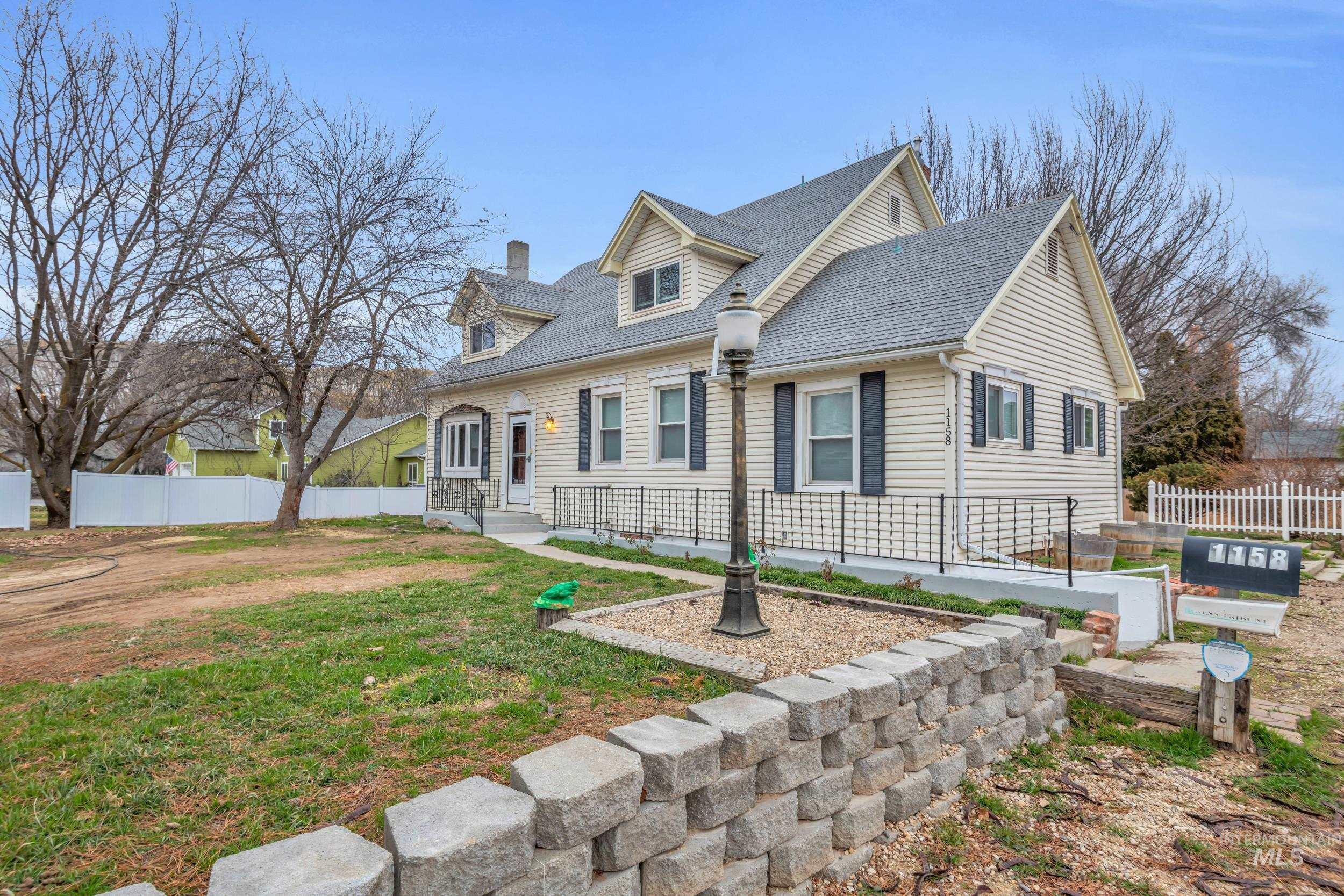 1158 South Powerline Road Nampa, ID 83686 - Photo 3 of 50 Cape cod house featuring roof with shingles and a chimney