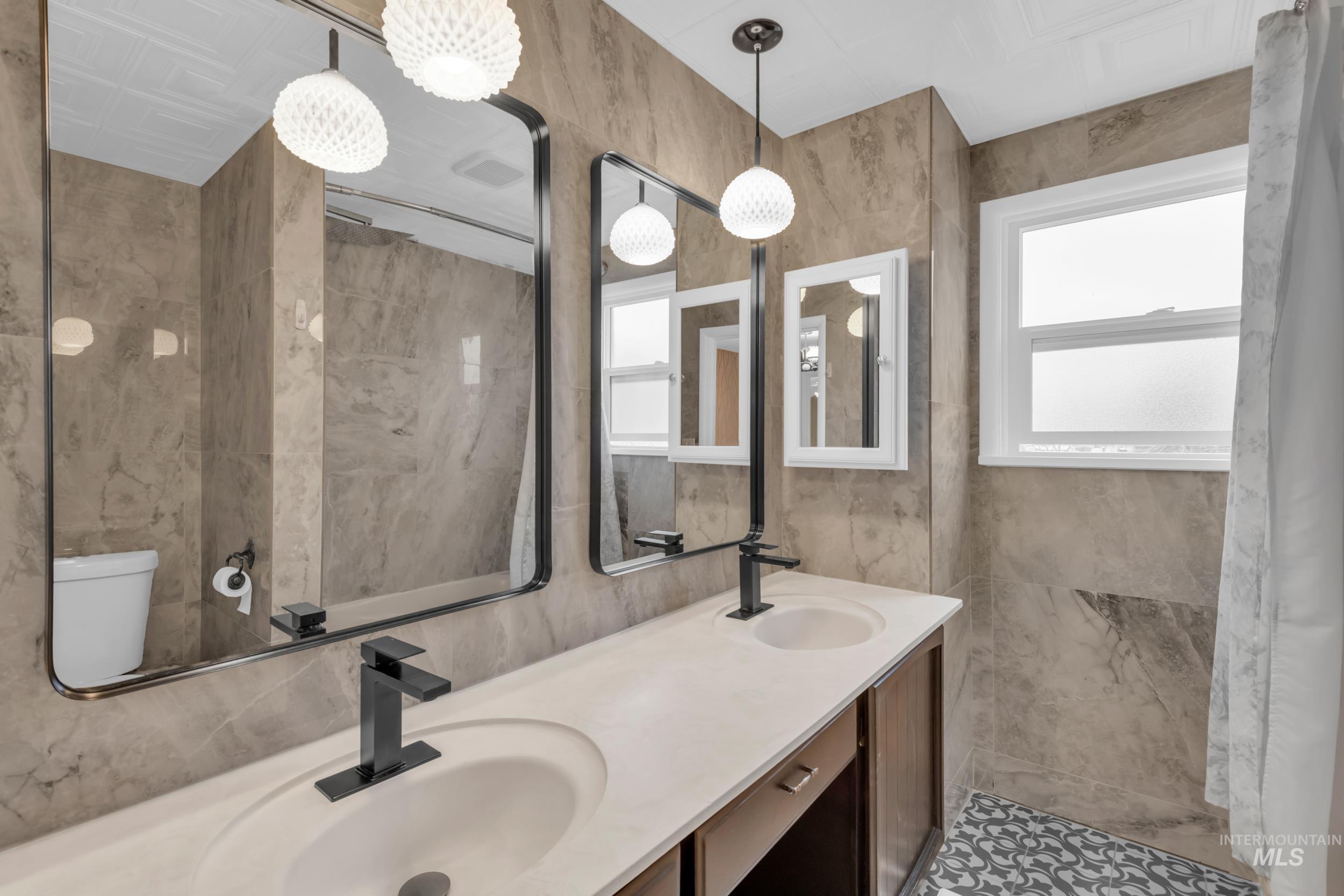 1158 South Powerline Road Nampa, ID 83686 - Photo 34 of 50 Full bathroom featuring tile walls and double vanity