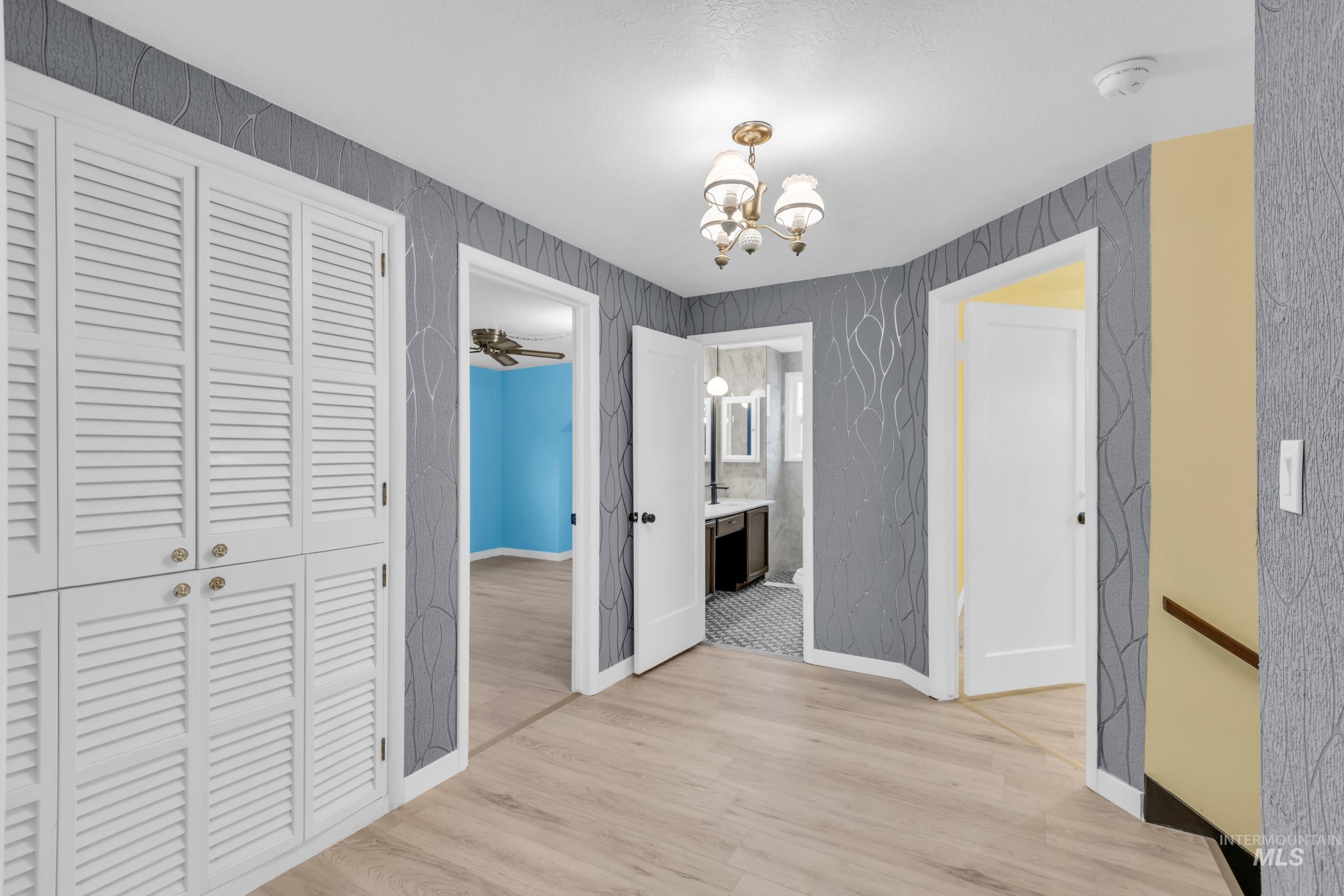 1158 South Powerline Road Nampa, ID 83686 - Photo 37 of 50 Hall featuring light wood-type flooring and a chandelier