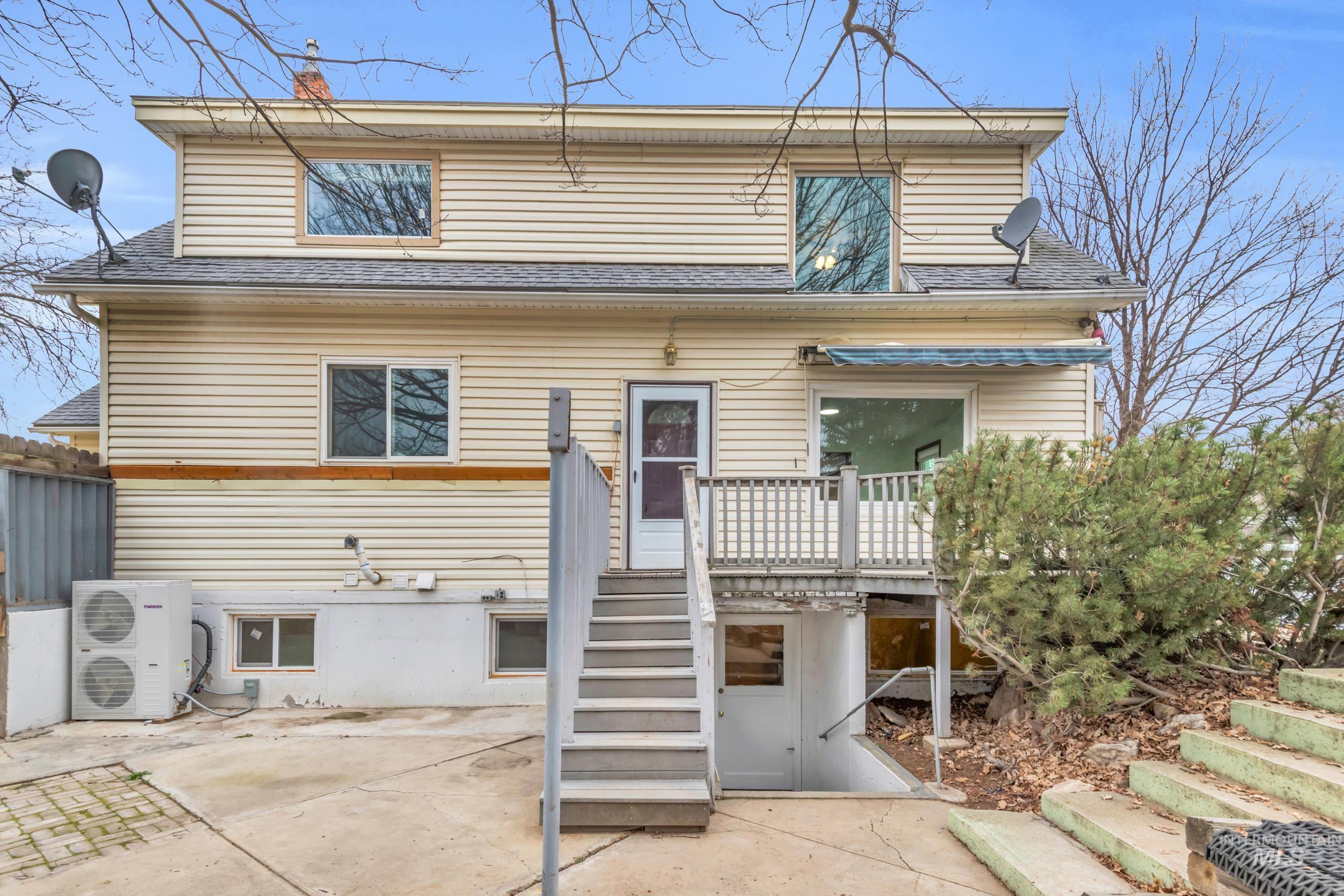 1158 South Powerline Road Nampa, ID 83686 - Photo 40 of 50 Rear view of property featuring a patio area, a shingled roof, a deck, and stairway