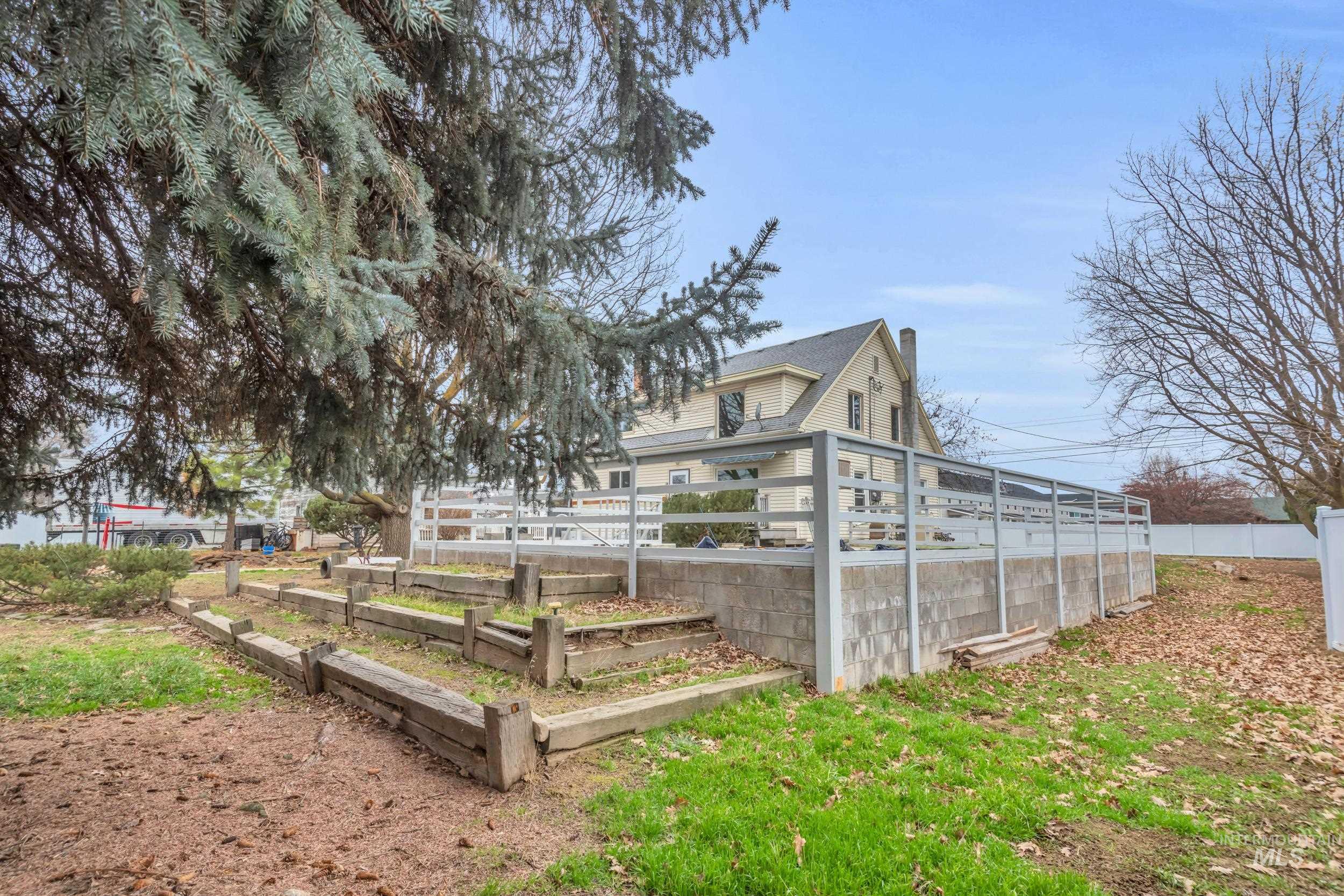 1158 South Powerline Road Nampa, ID 83686 - Photo 46 of 50 Exterior space featuring a vegetable garden and a chimney