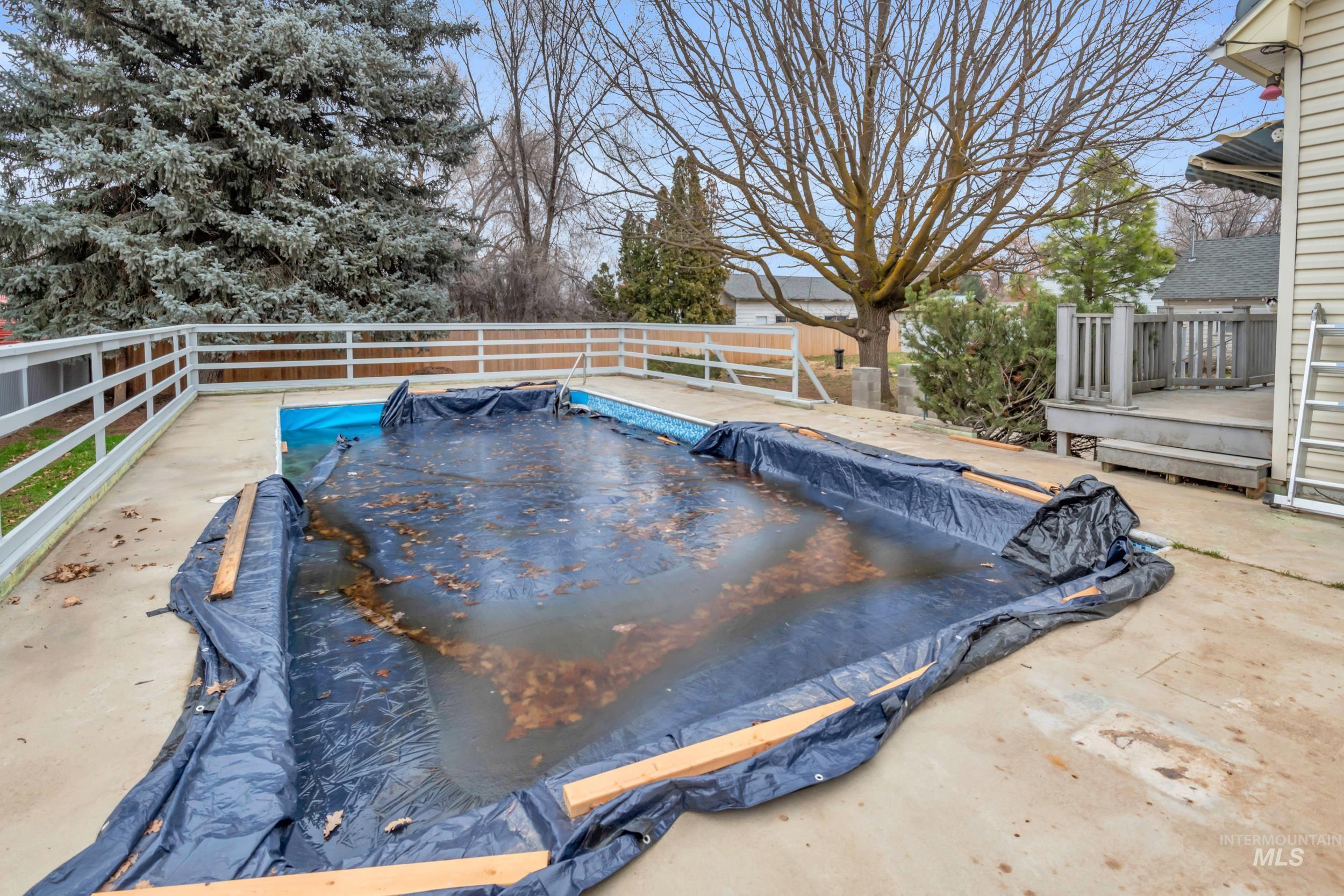 1158 South Powerline Road Nampa, ID 83686 - Photo 8 of 50 View of pool with a wooden deck and a fenced backyard