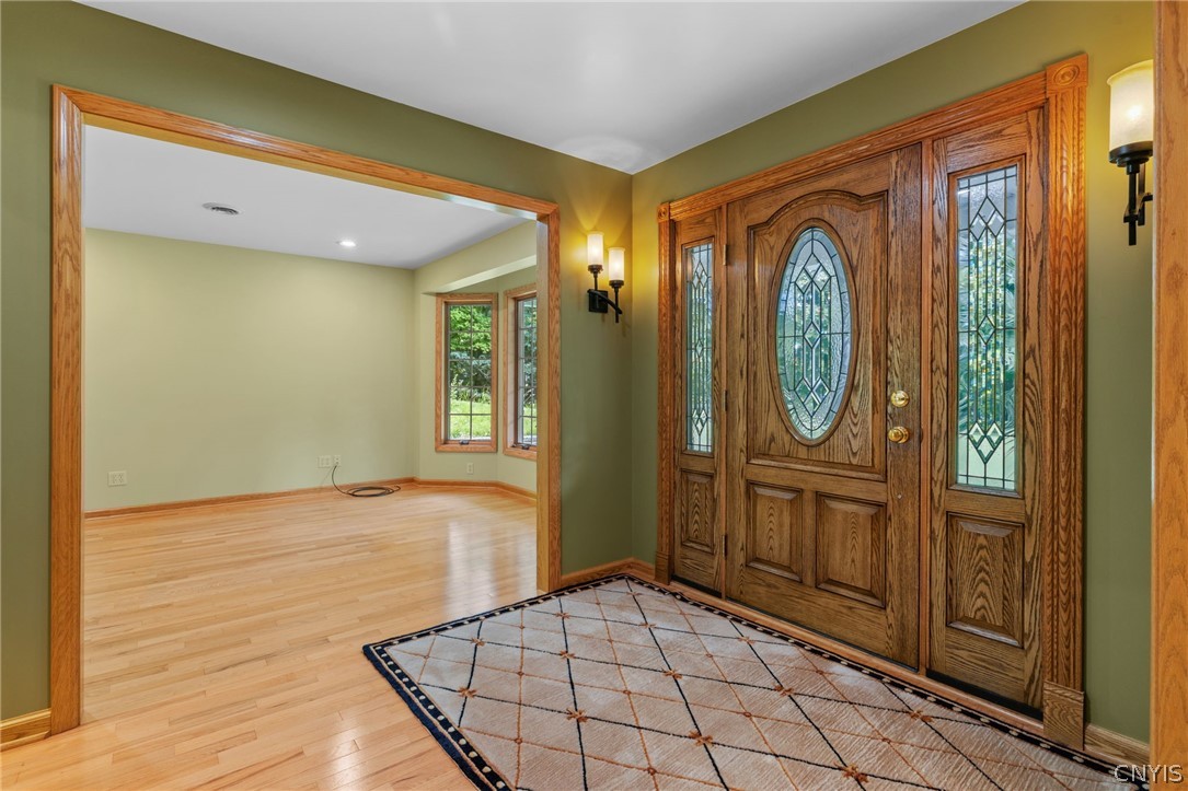 1103 Rail Fence Road Camillus, NY 13031 - Photo 8 of 50 Large foyer with gleaming hardwood floors throughout, recessed lighting in every room and much natural light.