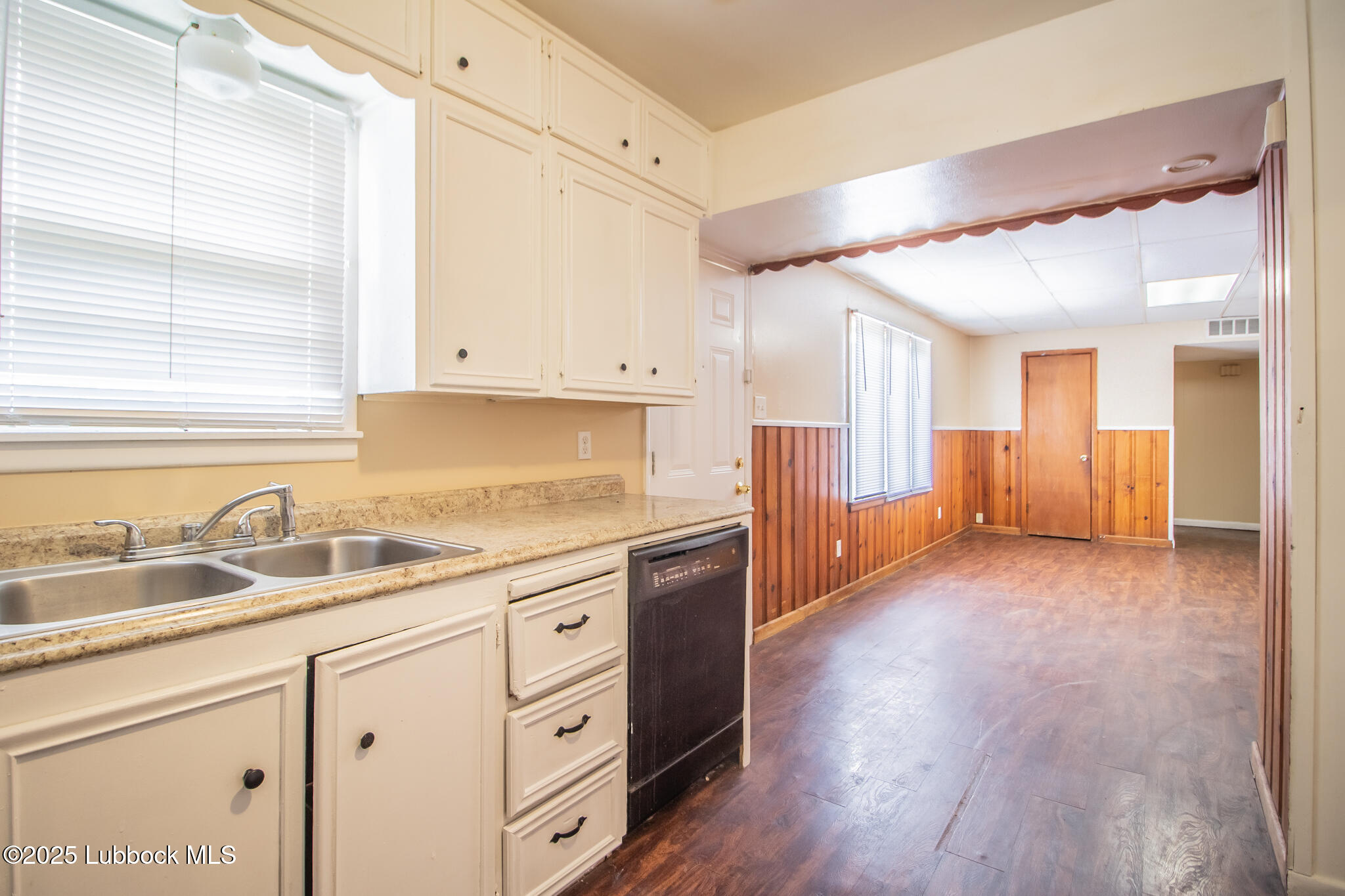 2414 38th Street Lubbock, TX 79412 - Photo 11 of 20 a kitchen with granite countertop a sink window and cabinets