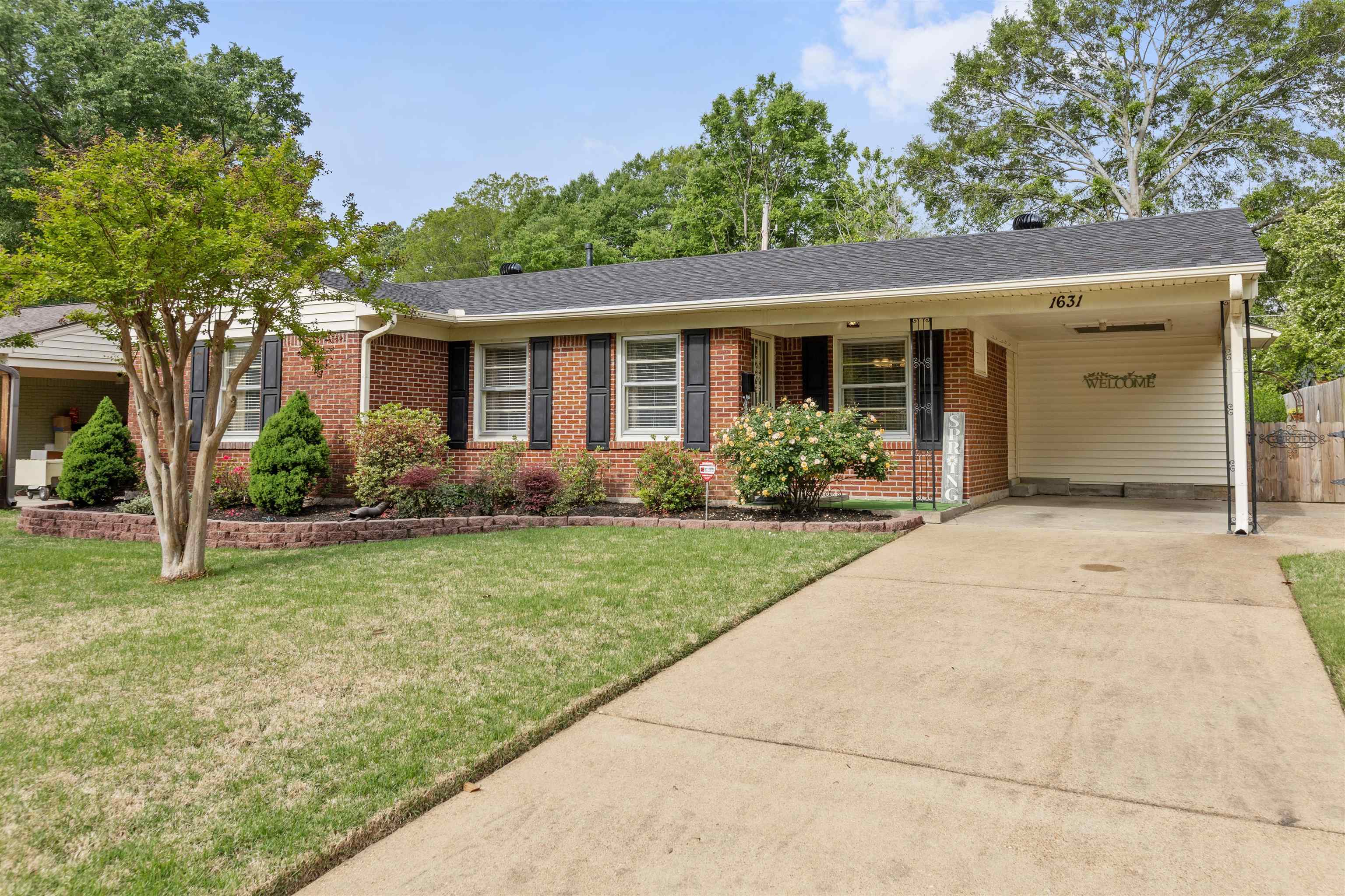1631 Hopewell Road Memphis, TN 38117 - Photo 1 of 22 front view of a house with a yard