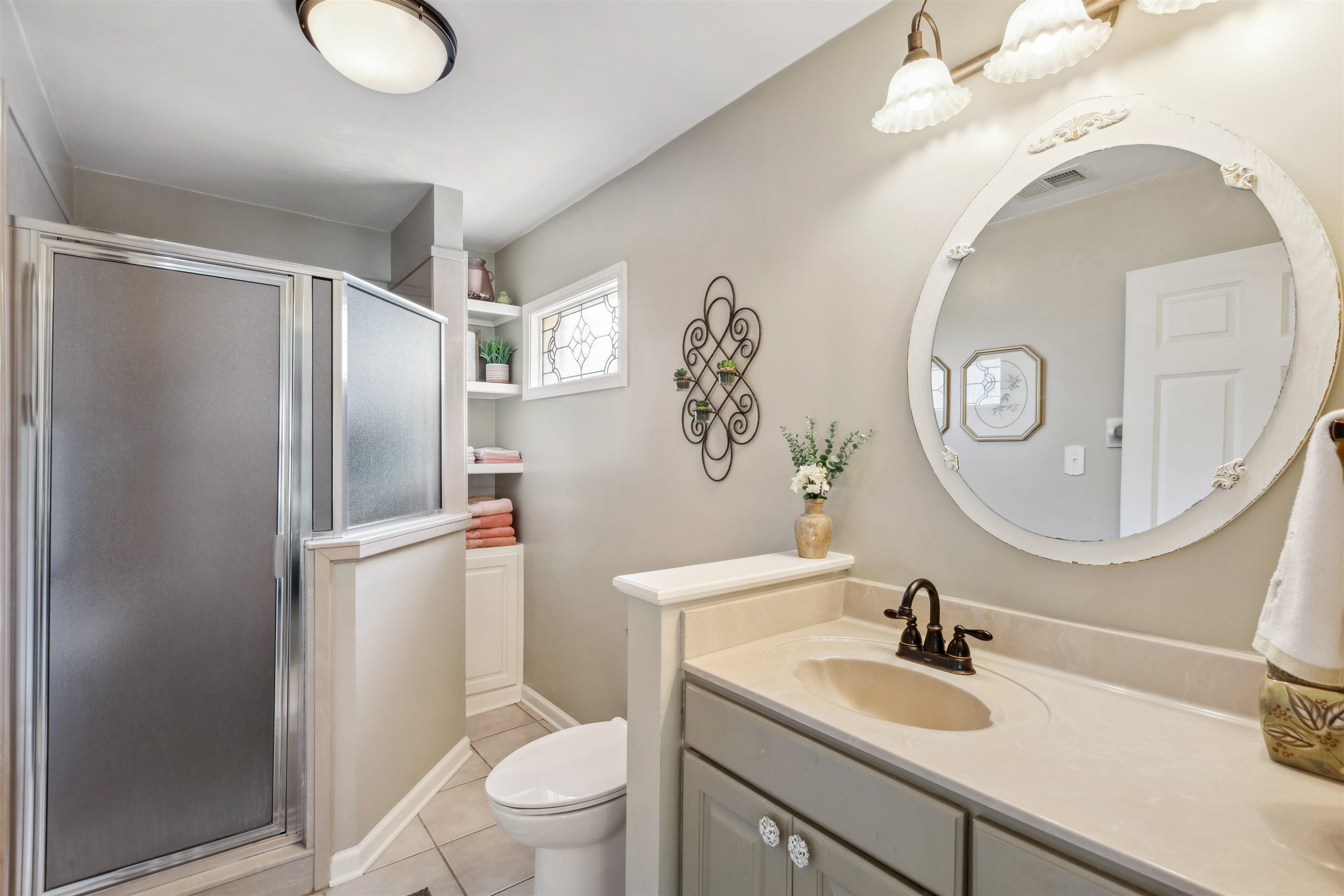 1631 Hopewell Road Memphis, TN 38117 - Photo 14 of 22 a bathroom with a granite countertop sink toilet and a mirror
